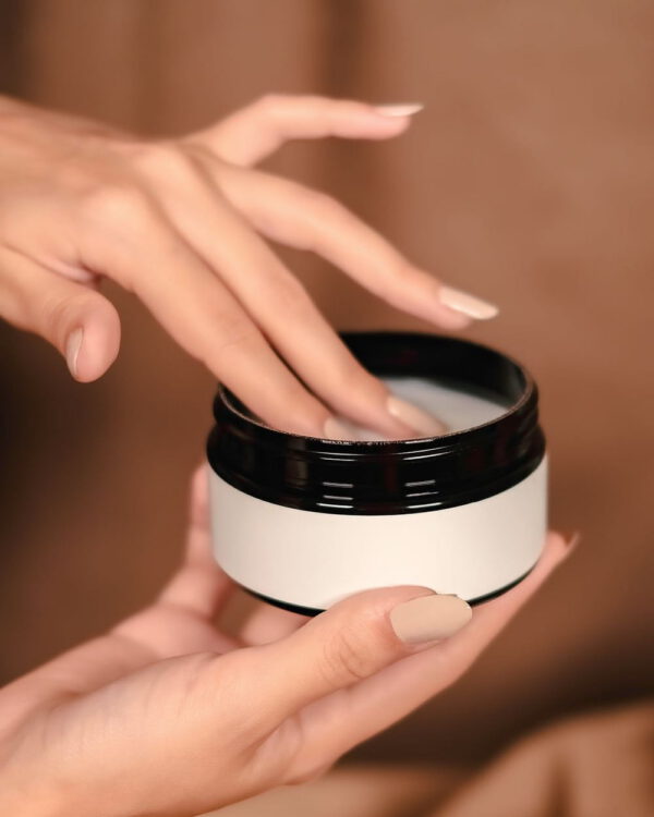 Calming Cleansing Balm Hands holding an open jar of cleansing balm